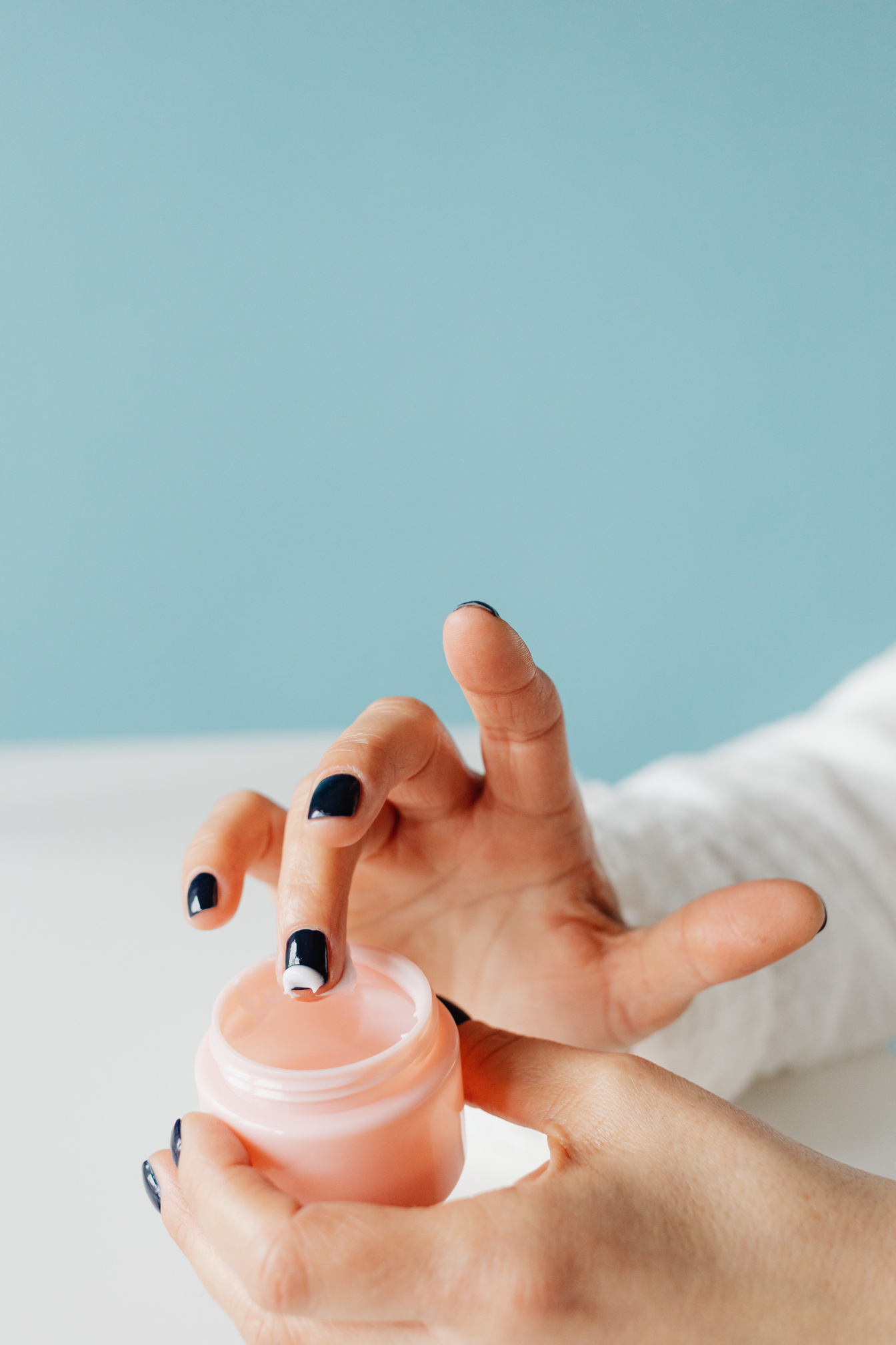 Person Holding a Cosmetic Product in Close Up Photography