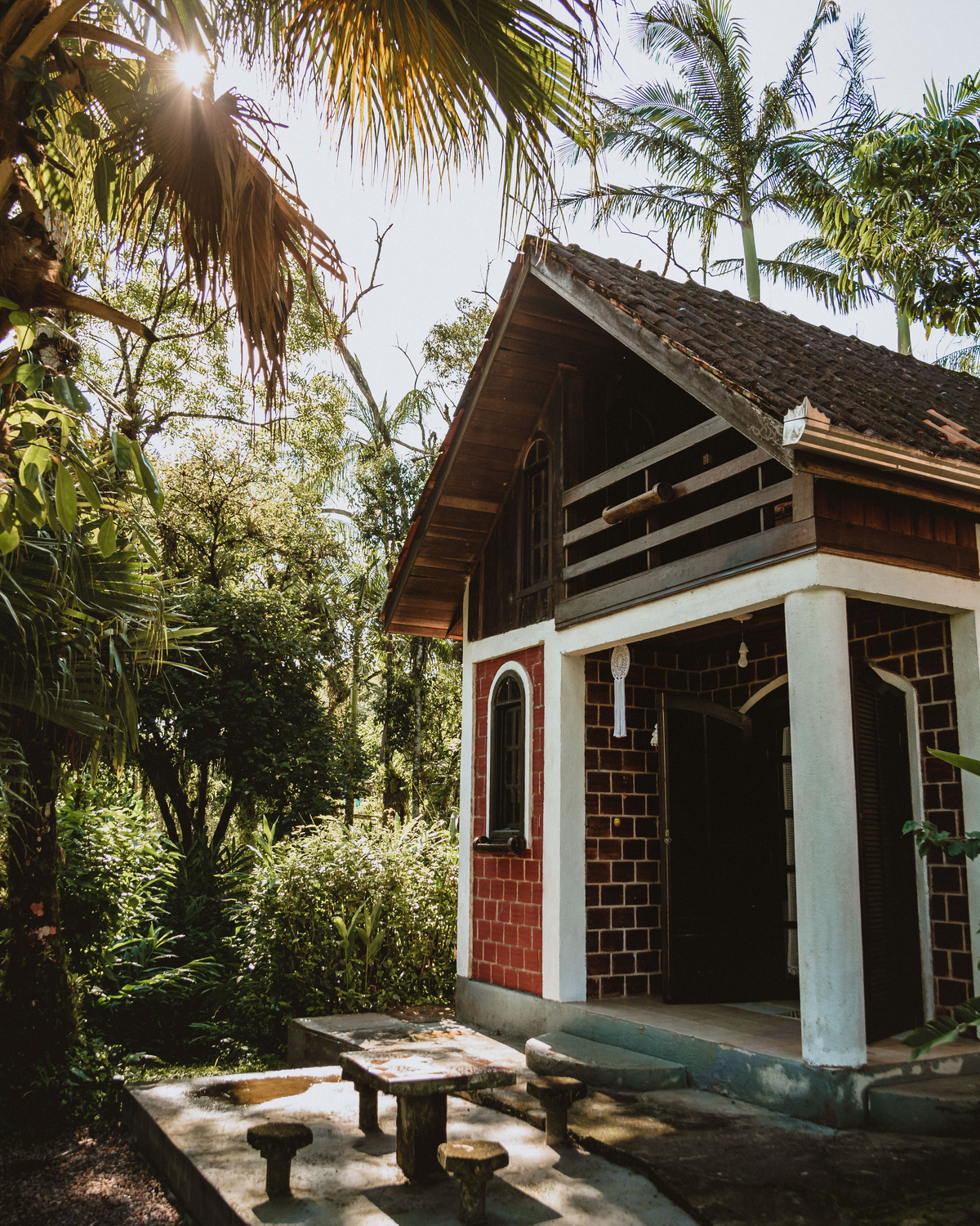 Brick House Surrounded by Plants and Trees